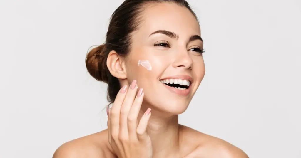 Woman applying Medical-Grade Skincare in San Angelo, TX, to her face for daily protection in Sanford, FL